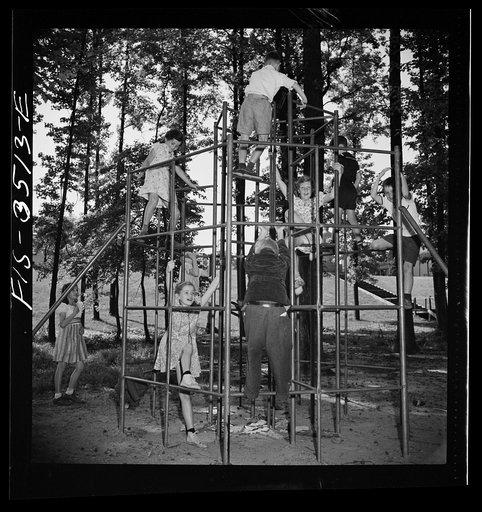 Greenbelt, Maryland. Federal housing project. Children playing on apparatus in one of the numerous playgrounds situated in shady groves