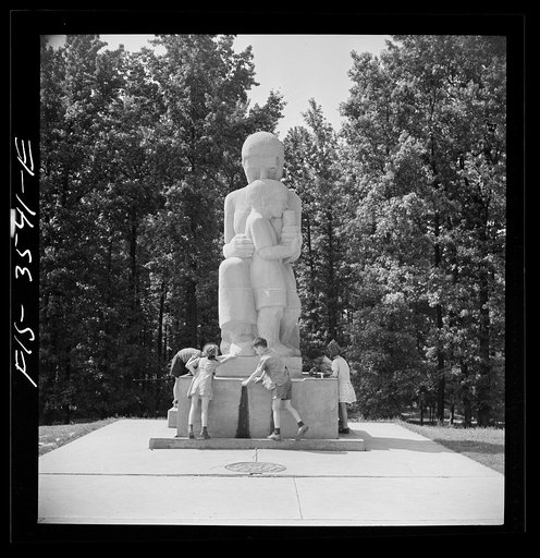Greenbelt, Maryland. Federal housing project. Children at the drinking fountain in the shopping center square. Playground is situated in a grove of trees behind the shopping center