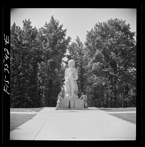 Untitled photo, possibly related to: Greenbelt, Maryland. Federal housing project. Children at the drinking fountain in the shopping center square. Playground is situated in a grove of trees behind the shopping center