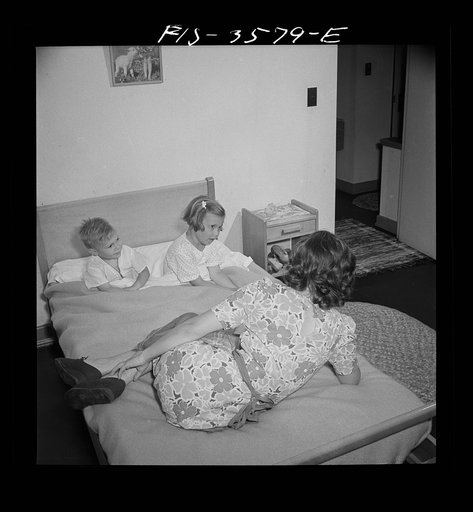 Greenbelt, Maryland. Mrs. Atkins reading a story to Ann and Pierce before bedtime