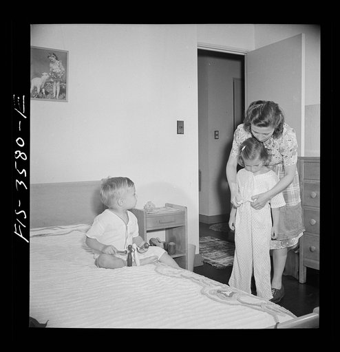 Untitled photo, possibly related to: Greenbelt, Maryland. Mrs. Atkins putting Ann to bed in her room. Pierce has a room of his own