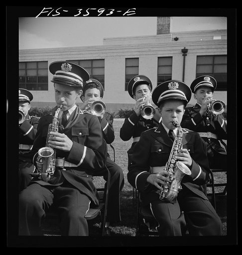 Greenbelt, Maryland. High school band in green uniforms giving a band concert on Memorial Day. Membership in the band is competitive, on the basis of talent. The band bought secondhand instruments and reconditioned them. It had made itself completely self-sufficient financially by giving benefit per