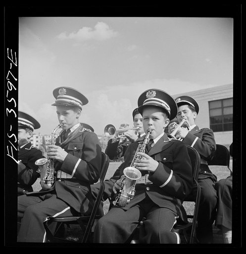 Untitled photo, possibly related to: Greenbelt, Maryland. High school band in green uniforms giving a band concert on Memorial Day. Membership in the band is competitive, on the basis of talent. The band bought secondhand instruments and reconditioned them. It had made itself completely self-suffici