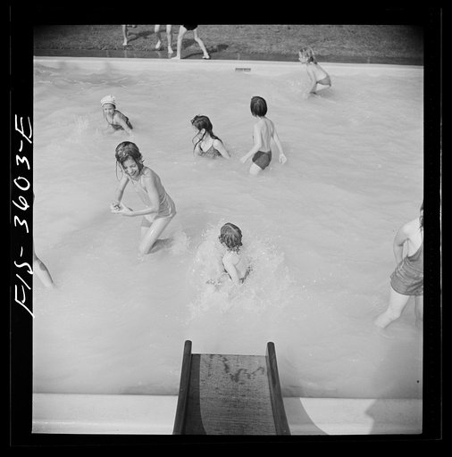 Untitled photo, possibly related to: Greenbelt, Maryland. A constant stream of water runs down the swimming pool slide