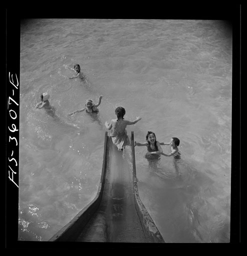 Untitled photo, possibly related to: Greenbelt, Maryland. A constant stream of water runs down the swimming pool slide