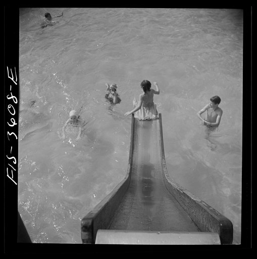 Untitled photo, possibly related to: Greenbelt, Maryland. A constant stream of water runs down the swimming pool slide