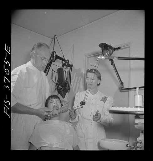 Greenbelt, Maryland. Dr. McCarl, Greenbelt dentist, treating a young patient