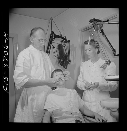 Untitled photo, possibly related to: Greenbelt, Maryland. Dr. McCarl, Greenbelt dentist, treating a young patient