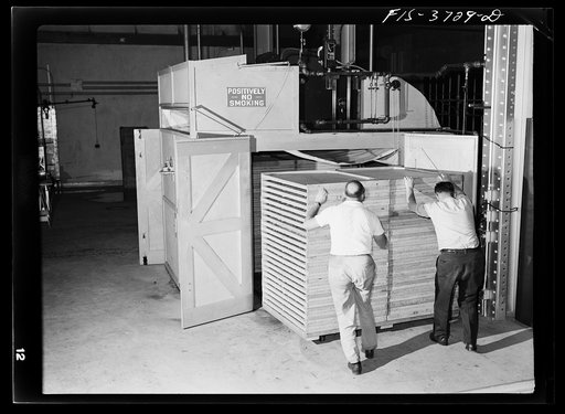 Pushing trays of cabbage into cabinet dryer for dehydration. Regional agricultural research laboratory, Albany, California