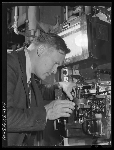 Untitled photo, possibly related to: G.T. Hemmeter, chief of the mechanical engineering section of the engineering and development division, sets one of the automatic recording thermometers used on tunnel dryer which he designed for dehydrating vegetables. Regional agricultural research laboratory, 