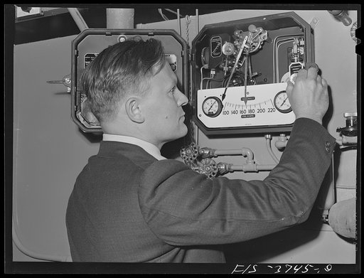 G.T. Hemmeter, chief of the mechanical engineering section of the engineering and development division, sets one of the automatic recording thermometers used on tunnel dryer which he designed for dehydrating vegetables. Regional agricultural research laboratory, Albany, California