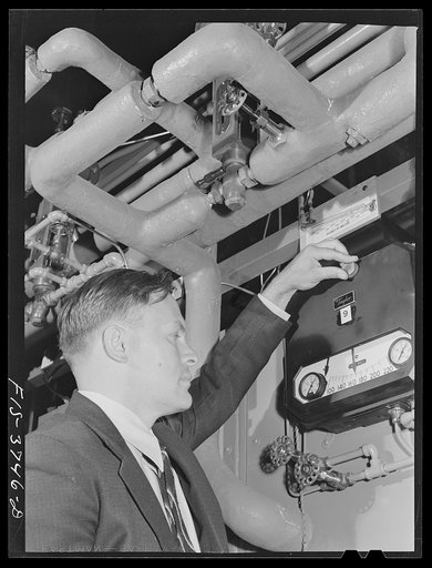 G.T. Hemmeter, chief of the mechanical engineering section of the engineering and development division, sets one of the automatic recording thermometers used on tunnel dryer which he designed for dehydrating vegetables. Regional agricultural research laboratory, Albany, California