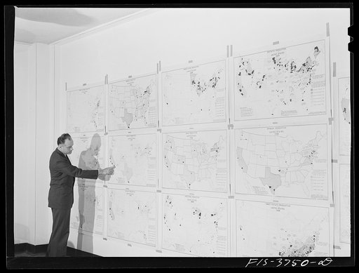 Untitled photo, possibly related to: Dr. W. D. Ramage, chief industrial analyst, with agricultural charts developed by his division showing areas of relative production of various vegetables. Regional agricultural research division, Albany, Calif