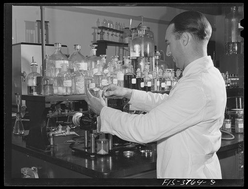 Untitled photo, possibly related to: Dr. G.I. Jones, associate chemist, weighs sample of dehydrated vegetable for vitamin B complex determination test. Regional agricultural research laboratory, Albany, California