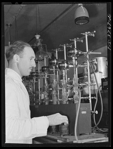Untitled photo, possibly related to: Dr. G.I. Jones, associate chemist, runs vitamin B complex determination test on dehydrated vegetables. Regional agricultural research laboratory, Albany, California