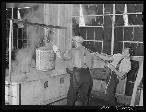Albany, California. Workers removing a container of chopped, blanched cabbage from a vat of hot water. By laboratory tests, it is determined which processing method retains the greatest percentage of vitamin content and produces the most attractive product