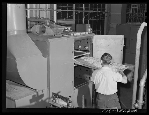 Putting tray of potatoes into small cabinet dryer for dehydration. Regional agricultural research laboratory, Albany, California