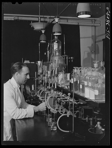 Dr. G.I. Jones, associate chemist, conducts tests in determination of vitamin B complex in dehydrated vegetables. Regional agricultural research laboratory, Albany, California. This test must be conducted in light of certain quality which will not destroy vitamins in solutions