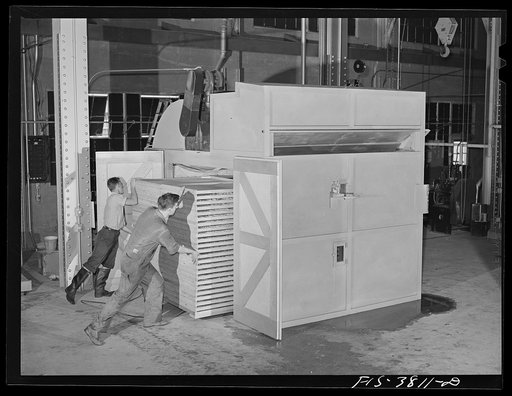 Putting trays of vegetables into cabinet dryer for dehydration. Regional agricultural research laboratory, Albany, California