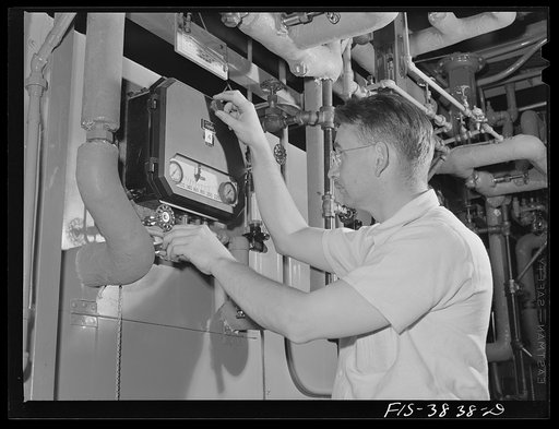 Horace Campbell, associate chemist, adjusts automatic thermal control of the tunnel dehydrater in use at the regional agricultural research laboratory, Albany, California