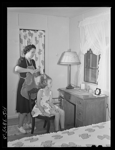 Untitled photo, possibly related to: Sheffield, Alabama (Tennessee Valley Authority (TVA)). Mrs. Hall combs daughter Peggy's hair. They live on a defense housing project