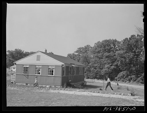 Untited photo, possibly related to: Sheffield, Alabama (Tennessee Valley Authority (TVA)). Kenneth Hall gives daughter Peggy a shower with garden hose in front of their TVA defense home
