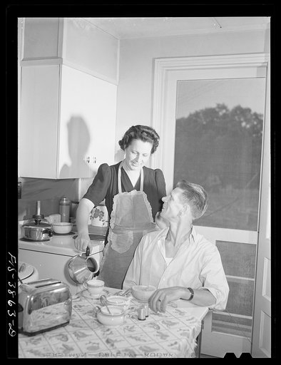 Sheffield, Alabama (Tennessee Valley Authority (TVA)). Mrs. Hall prepares breakfast for her husband before he leaves for work at the aluminum plant