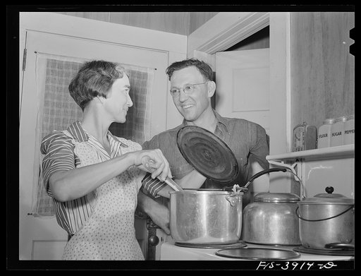 Lauderdale County, Alabama. Tennessee Valley Authority (TVA). Julien H. Case watching his wife cook on her electric stove