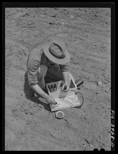 Untitled photo, possibly related to: Lauderdale County, Alabama. Tennessee Valley Authority (TVA). Julien H. Case makes full use of scientific methods on his farm. Here he is making a soil test