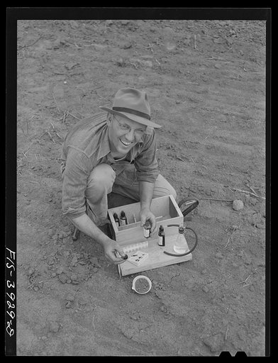 Lauderdale County, Alabama. Tennessee Valley Authority (TVA). Julien H. Case makes full use of scientific methods on his farm. Here he is making a soil test