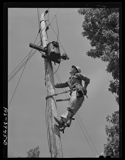 Lauderdale County, Alabama. Tennessee Valley Authority (TVA). Julien H. Case repairing the transformer which brings TVA electricity to his farm. Case uses 900 kilowatt hours each month