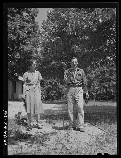 Lauderdale County, Alabama. Tennessee Valley Authority (TVA). Julien H. Case and his wife pitching horseshoes on their farm
