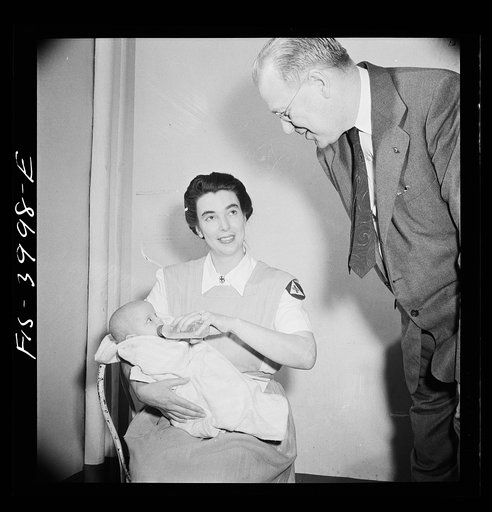 Untitled photo, possibly related to: Washington, D.C. Mr. Lund, who is head of the District Red Cross, visits the Children's Hospital where General MacArthur's niece is a nurse's aid