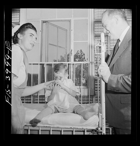 Untitled photo, possibly related to: Washington, D.C. Mr. Lund, who is head of the District Red Cross, visits the Children's Hospital where General MacArthur's niece is a nurse's aid