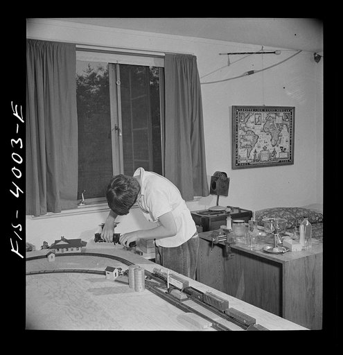 Greenbelt, Maryland. Child's bedroom in a house in which a thirteen year-old boy has rigged up model trains and a chemical laboratory