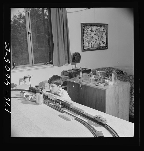 Greenbelt, Maryland. Child's bedroom in a house in which a thirteen year-old boy has rigged up model trains and a chemical laboratory