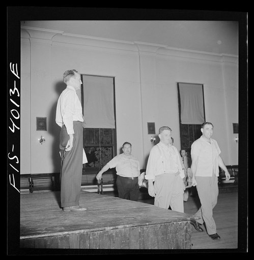 Untitled photo, possibly related to: Washington, D.C. The District Red Cross gives training to taxi drivers in using their cabs as emergency ambulances. Here they are practicing carrying a victim in and out of a cab on one of the new army stretchers