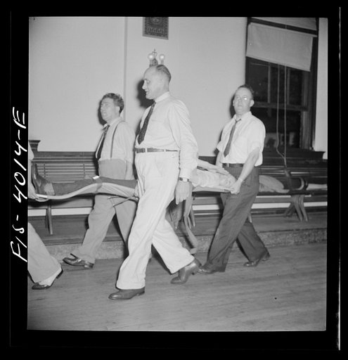 Untitled photo, possibly related to: Washington, D.C. The District Red Cross gives training to taxi drivers in using their cabs as emergency ambulances. Here they are practicing carrying a victim in and out of a cab on one of the new army stretchers