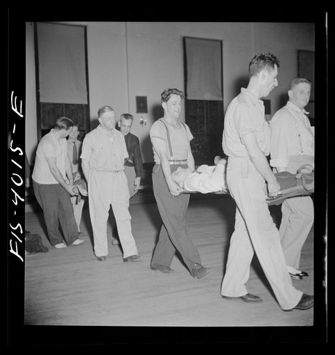 Untitled photo, possibly related to: Washington, D.C. The District Red Cross gives training to taxi drivers in using their cabs as emergency ambulances. Here they are practicing carrying a victim in and out of a cab on one of the new army stretchers