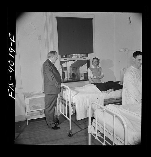 Untitled photo, possibly related to: Washington, D.C. Mr. Lund, who is the head of the District Red Cross, watching a volunteer blood donor give her blood at the Washington blood donor center