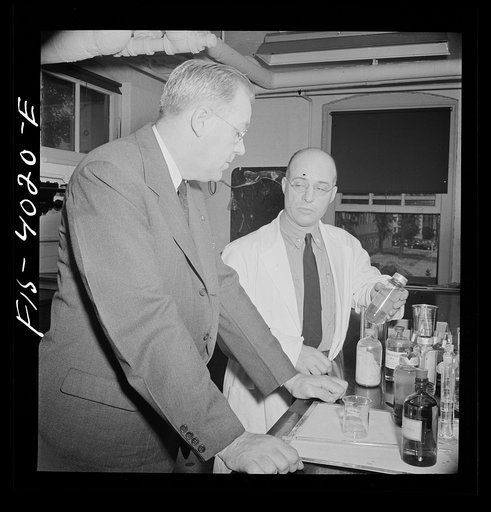 Untitled photo, possibly related to: Washington, D.C. Mr. Lund, who is head of the District Red Cross, watching the testing of blood plasma at the District blood donor center