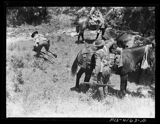 Untitled photo, possibly related to: Fort Riley, Kansas. Setting a light air-cooled machine gun during a field problem of the cavalry
