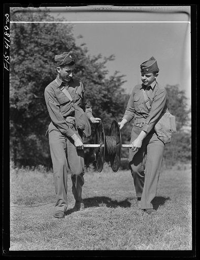 Fort Riley, Kansas. Signal Corps men stringing wire during a field problem