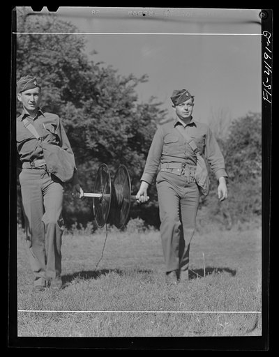 Untitled photo, possibly related to: Fort Riley, Kansas. Signal Corps men stringing wire during a field problem