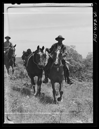 Untitled photo, possibly related to: Fort Riley, Kansas. Leading a pack horse carrying a machine gun during a field problem of the cavalry