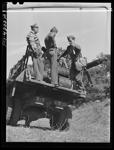 Fort Riley, Kansas. Laying wire from a truck of the Signal Corps during a field problem