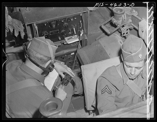 Fort Riley, Kansas. Communicating by radio from a scout car during a field problem of a Signal Corps unit