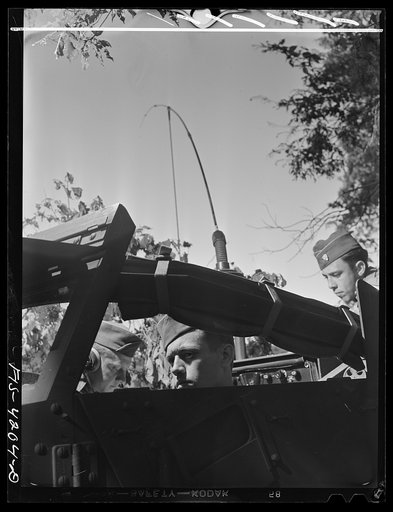Fort Riley, Kansas. Communicating by radio from a scout car during a field problem of a Signal Corps unit