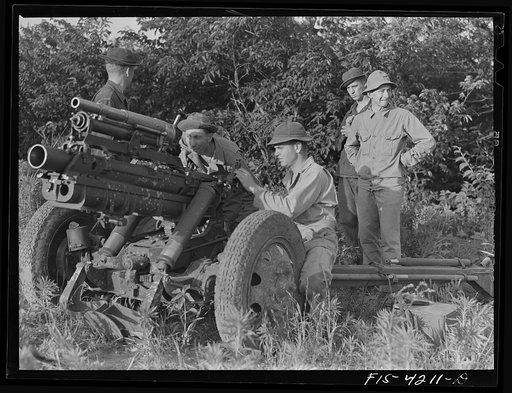 Fort Riley, Kansas. Lining up guns during artillery practice. The small thirty seven mm gun mounted on the howitzer is used only in training