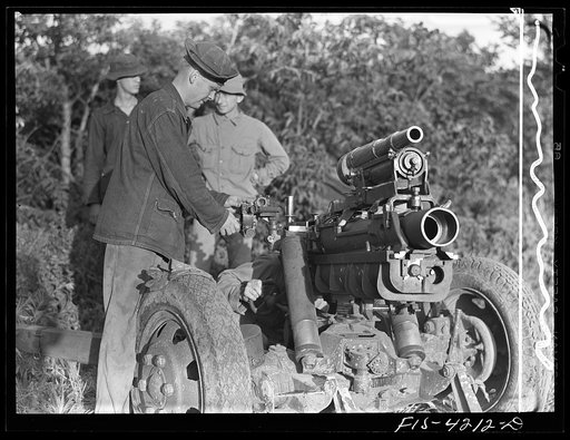 Fort Riley, Kansas. Lining up guns during artillery practice. The small thirty seven mm gun mounted on the howitzer is used only in training